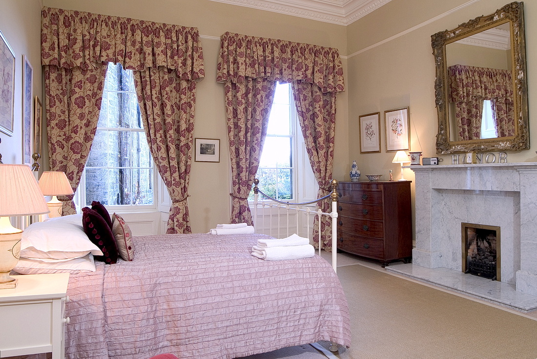 Master bedroom with king-size bed and marble fireplace
