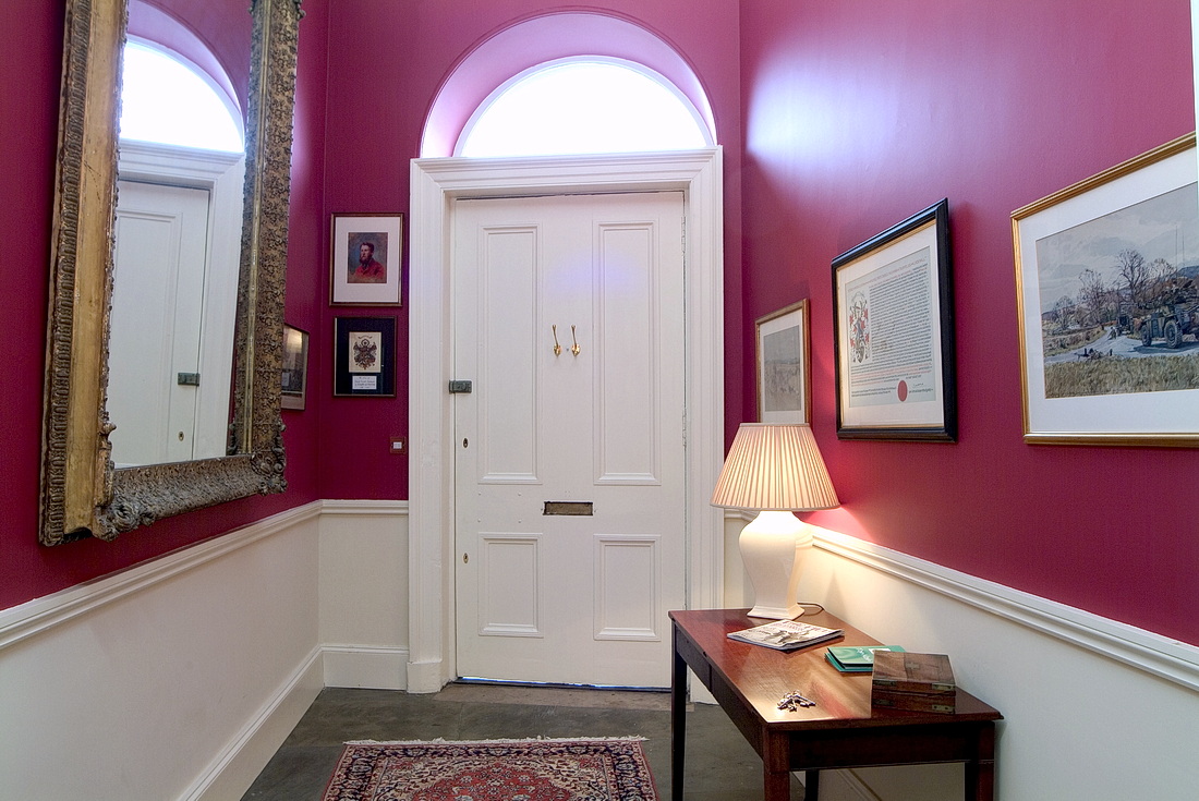 Entrance hall with antique mirror and original flag stones
